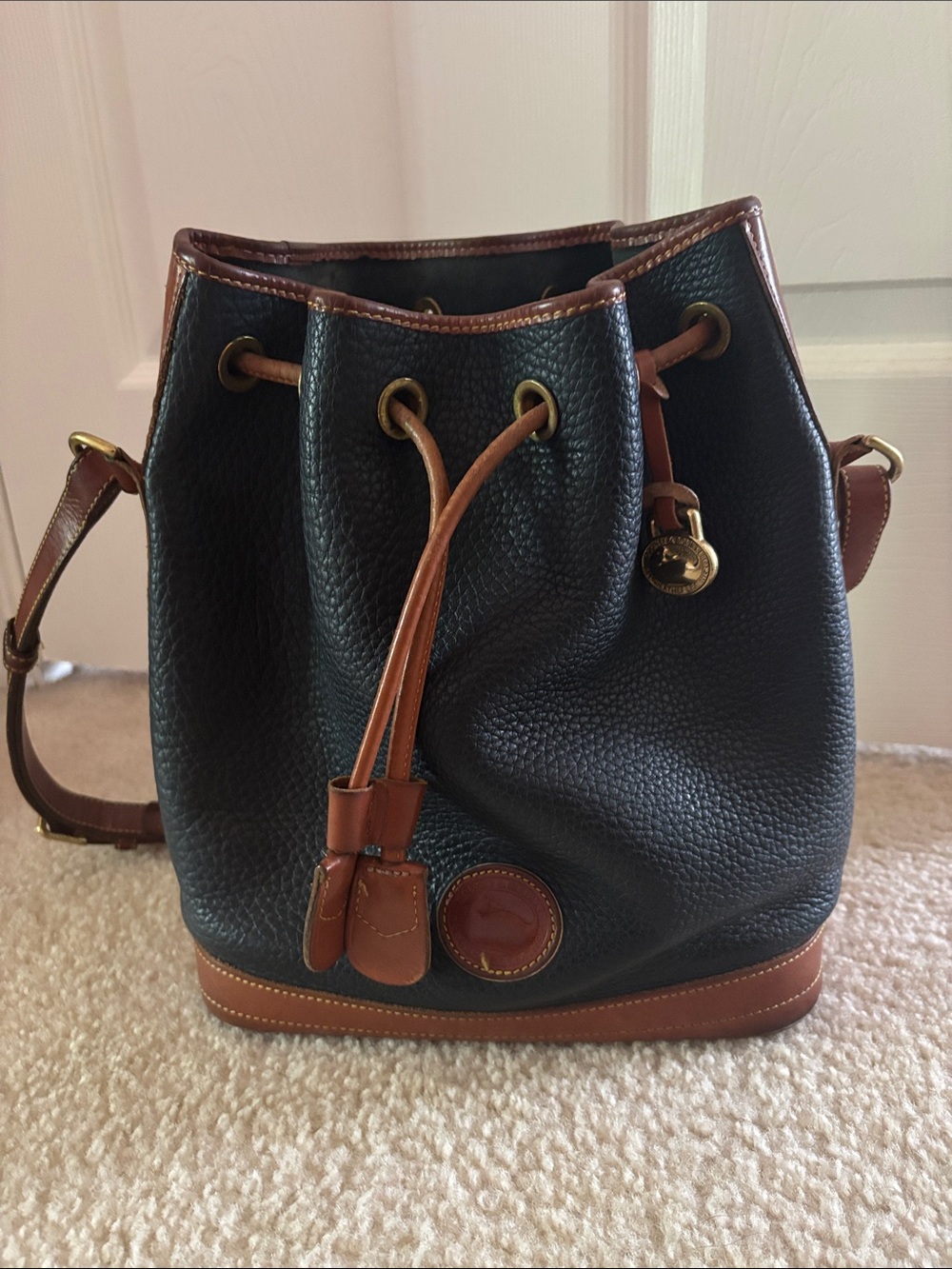 Dooney & Bourke Black Pebbled Leather Drawstring Bucket Bag with Brown Trim